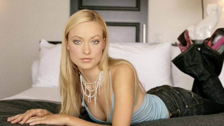 Olivia Wilde Laying Pose In Blue Top And Black Jeans